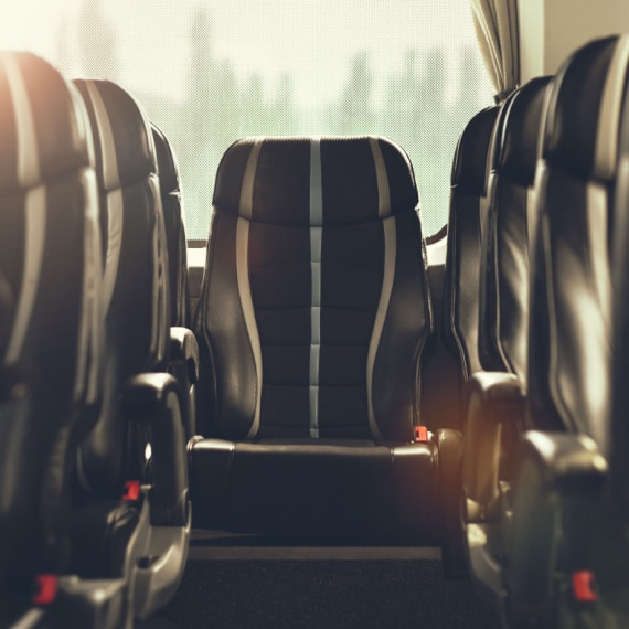 a black seat at the back of a row of seats on a charter bus