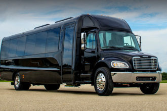 a plain black minibus parked on pavement